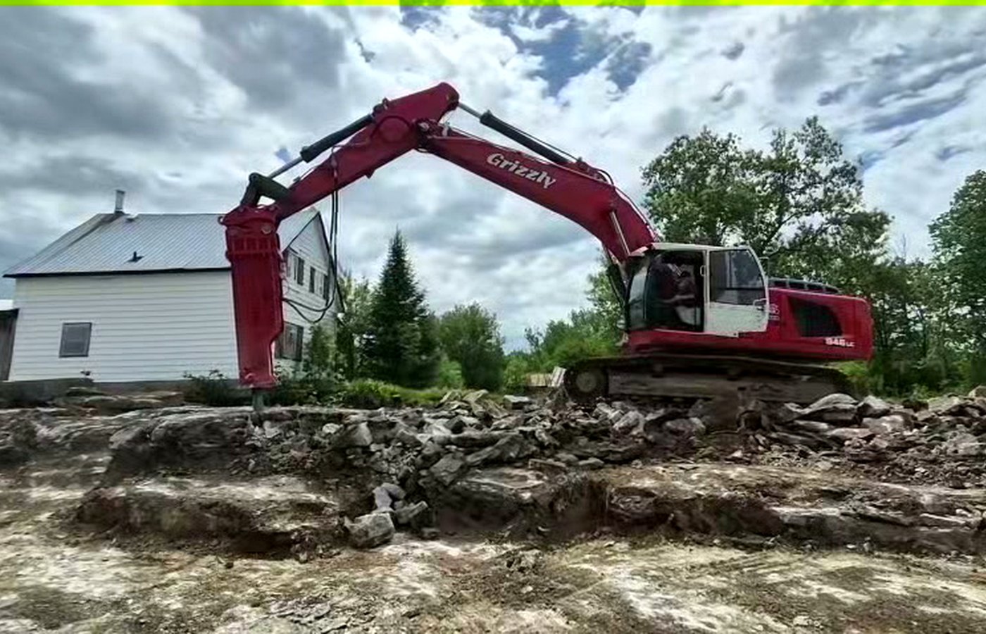 Crawler excavator with demolition hammer in an urban concrete site