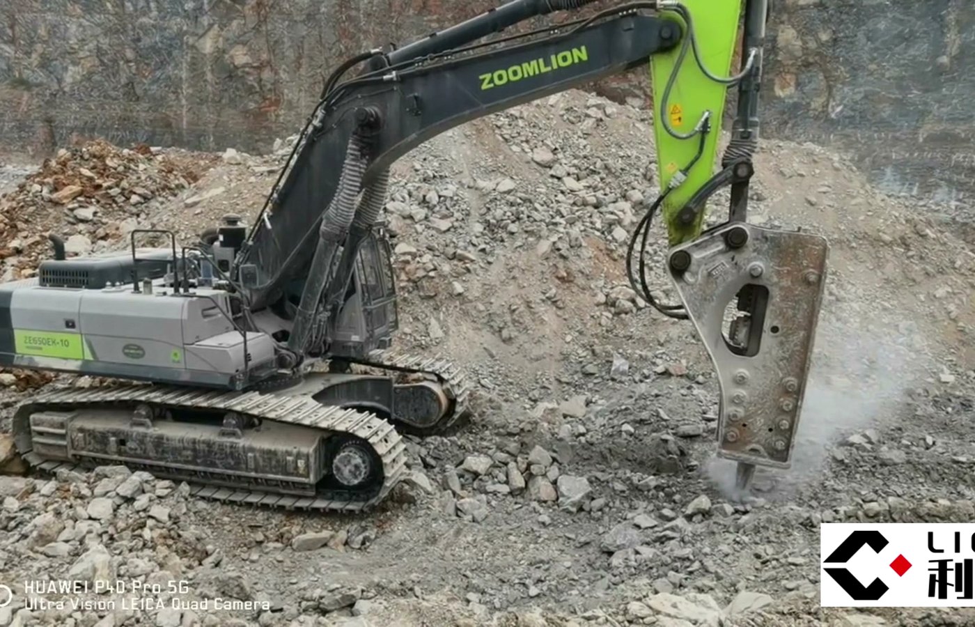 Backhoe loader with hydraulic breaker on a road worksite